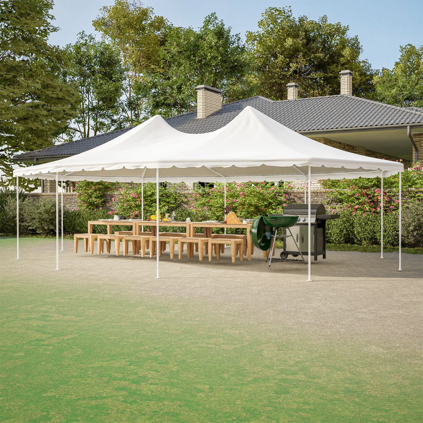 White outdoor canopy tent set up in a backyard with a table and grill underneath.