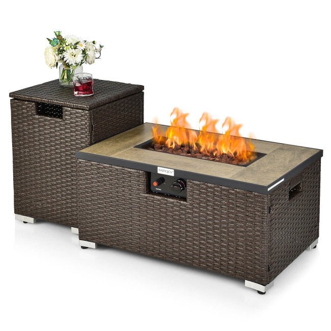 Outdoor fire pit table with wicker design and a small table on top holding a glass of red wine and flowers.