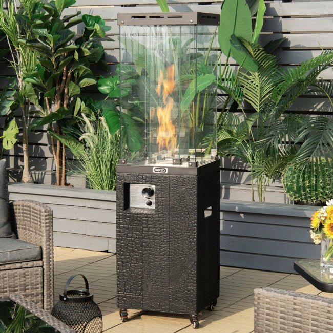 Outdoor patio with a fire pit table, chairs, and plants