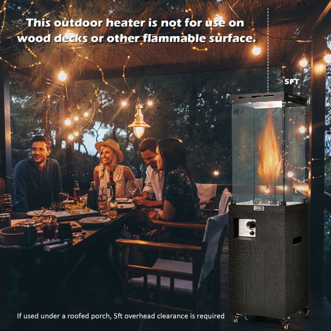 People enjoying a meal outdoors with an outdoor heater in the foreground.