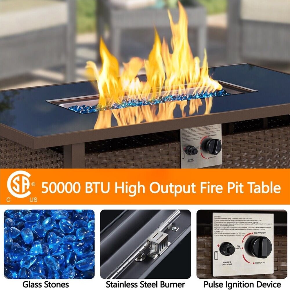 50000 BTU High Output Fire Pit Table with flames, glass stones, burner, and ignition device on a blurred outdoor background.
