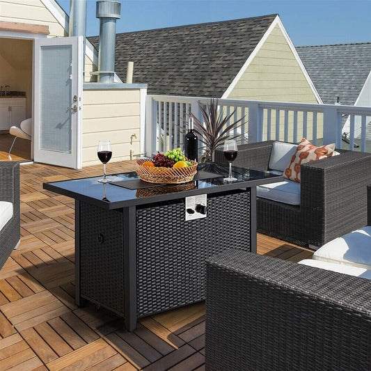 Outdoor patio set with a fire pit table on a wooden deck.