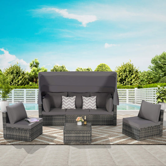 Outdoor patio furniture set with gray cushions on a patio with a pool and garden view.