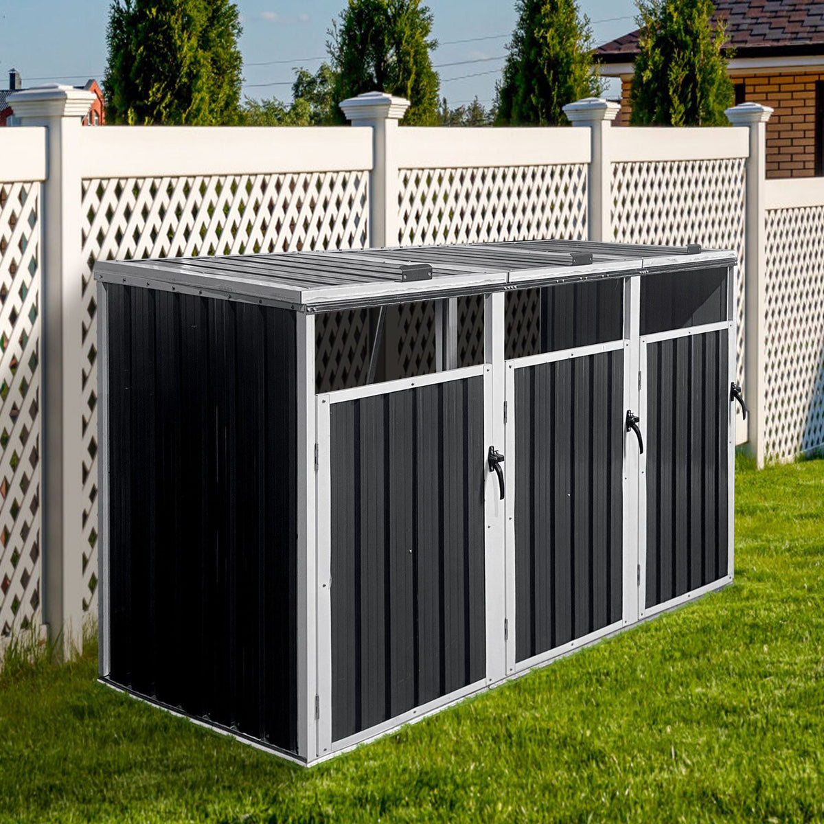 Black outdoor storage shed with gray roof on grass, white fence in background