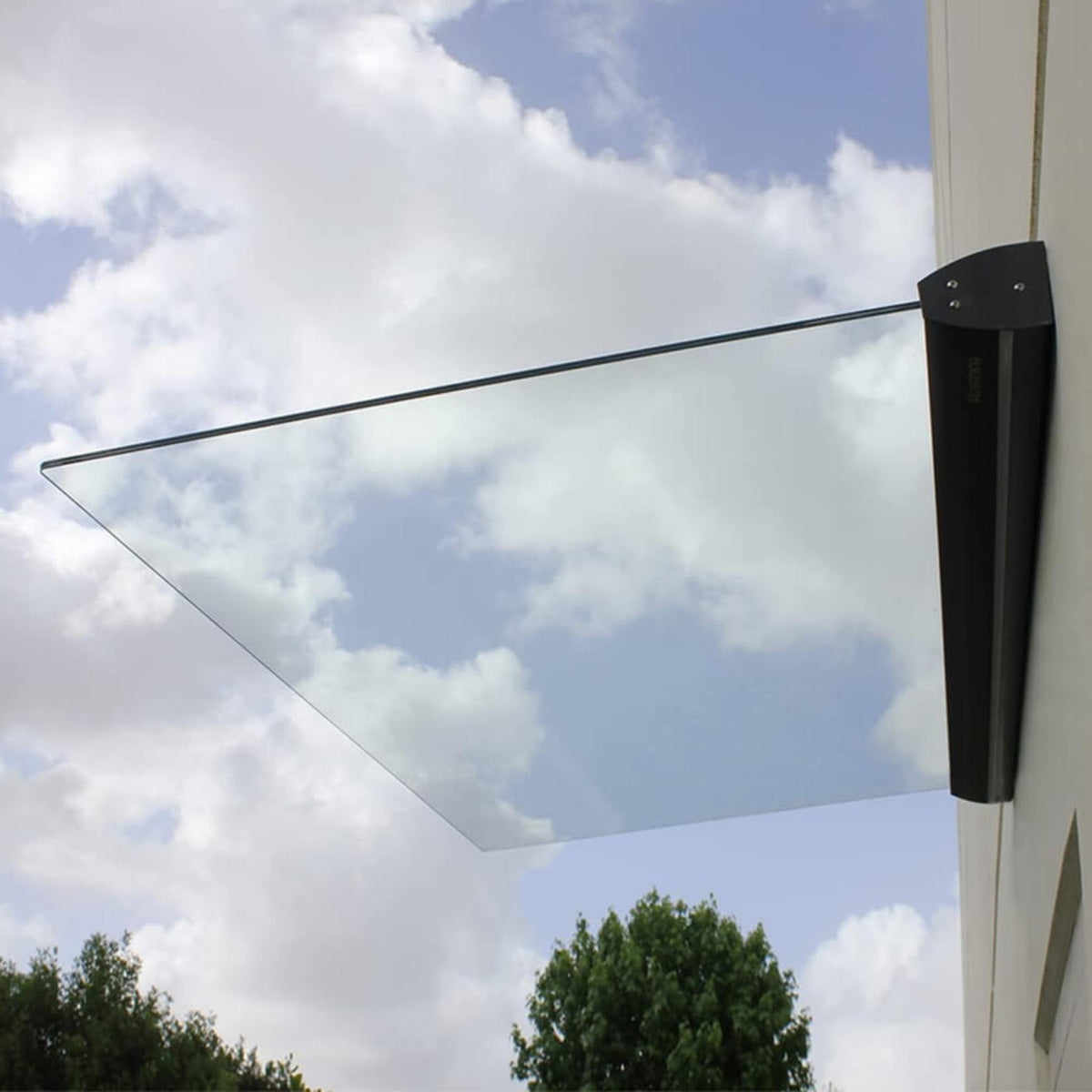 Glass panel with metal bracket against a blue sky with clouds