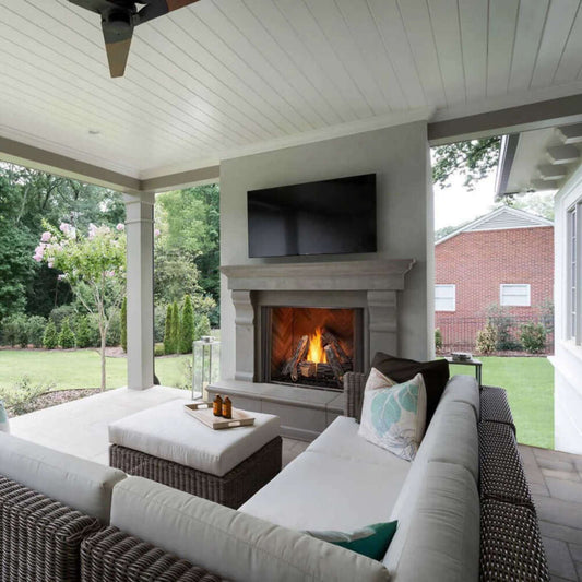 Outdoor patio with fireplace, TV, and comfortable seating area.