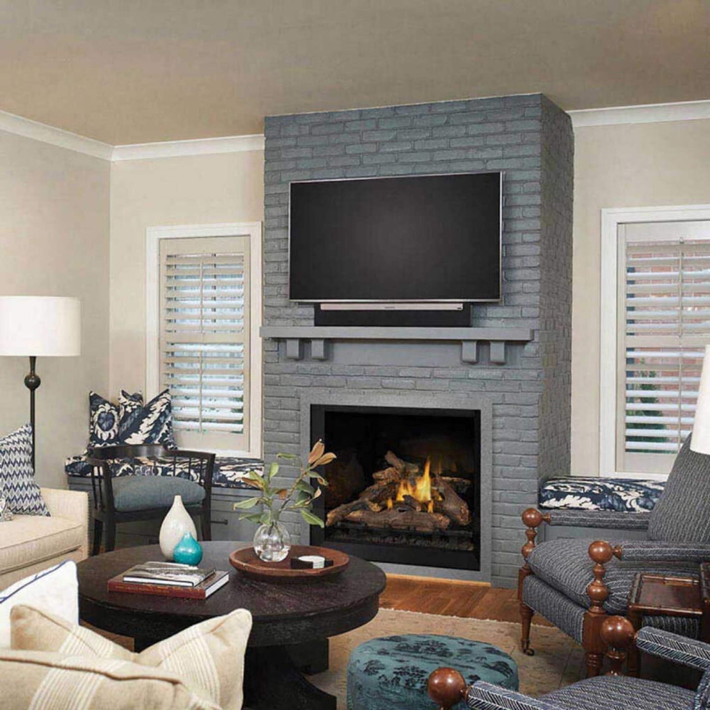 Living room with gray brick fireplace, TV, and furniture.