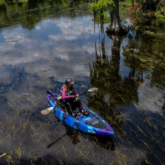 Angler using Vibe Yellowfin 120 kayak equipped with fishing gear