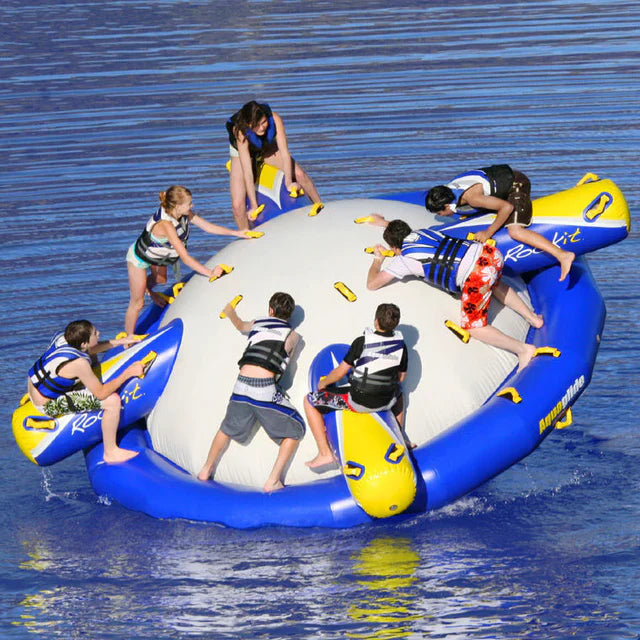 Group rocking on the Aquaglide Rockit, a 13 ft circular water rocker, in a lake aquapark setup