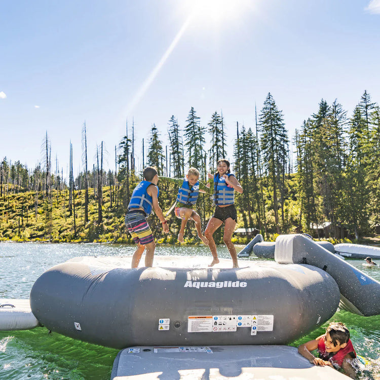 Water trampoline and bouncer setup, featuring a springless bouncer, floating in a lake for family fun