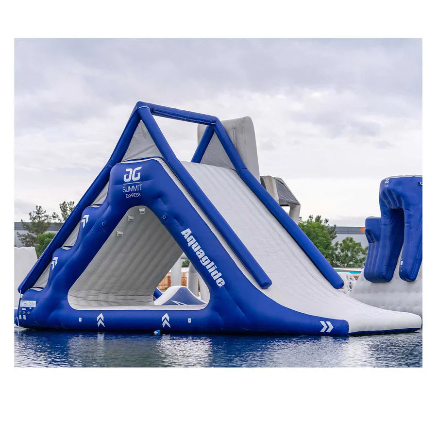 Family jumping on the Aquaglide Recoil trampoline, a signature Aquaglide aquapark feature, on a sunny lake day.