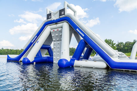Aquaglide Signature Aquapark Features, including bouncers and trampolines, set up in an open water lake for fun and excitement.
