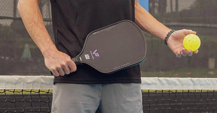 Player holding a pickleball paddle, ready for action, featuring premium pickleball equipment designed for top performance