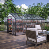 Greenhouse with plants on a wooden deck with outdoor furniture