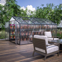 Greenhouse with plants on a wooden deck with outdoor furniture