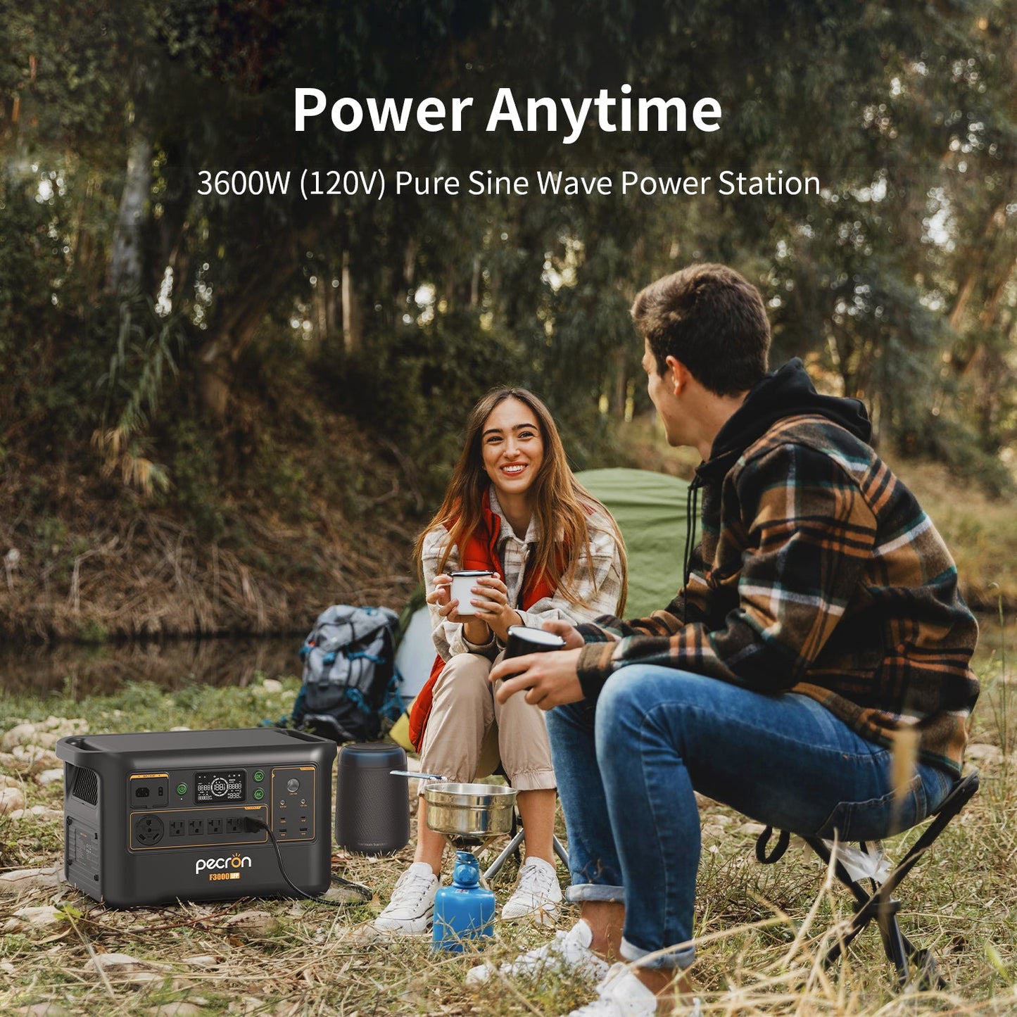 Two people sitting outdoors with a power station, camping scenario.