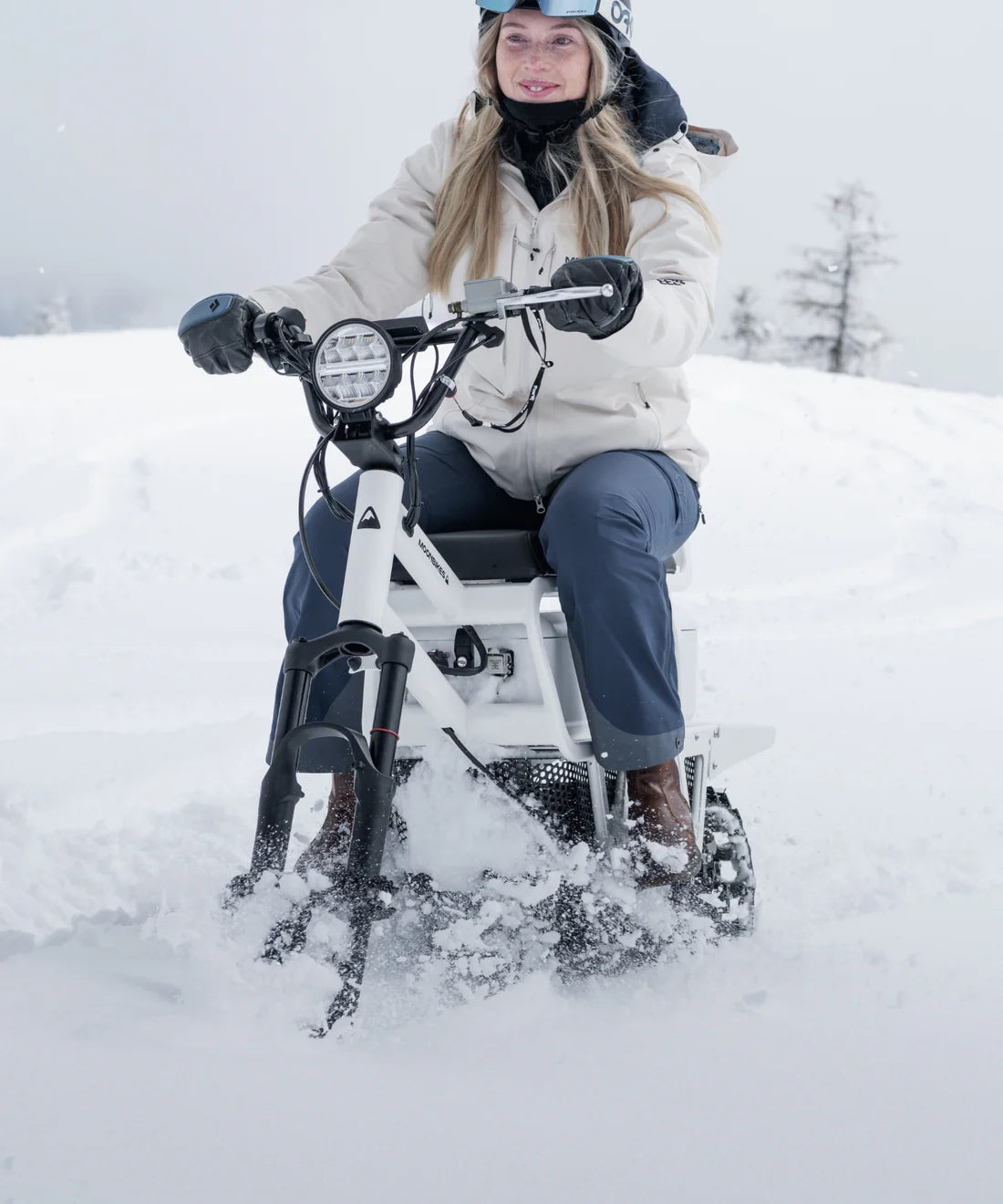 Person riding a snow bike in the snow