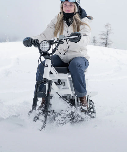 Person riding a snow bike in the snow