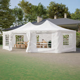 White outdoor gazebo with curtains on a grassy area with trees in the background