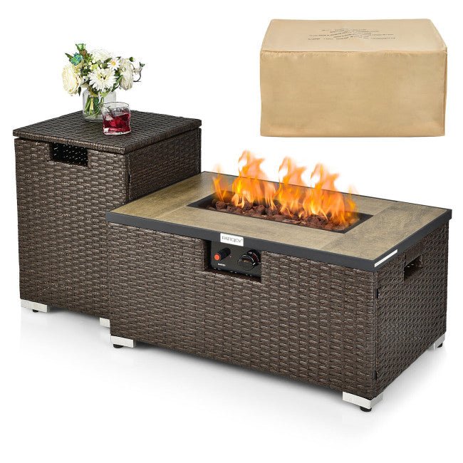 Wicker fire pit table with flames, a glass of red wine, and a vase of flowers on a white background.