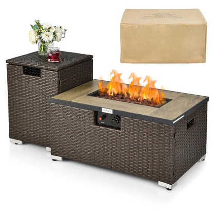 Wicker fire pit table with flames, a glass of red wine, and a vase of flowers on a white background.