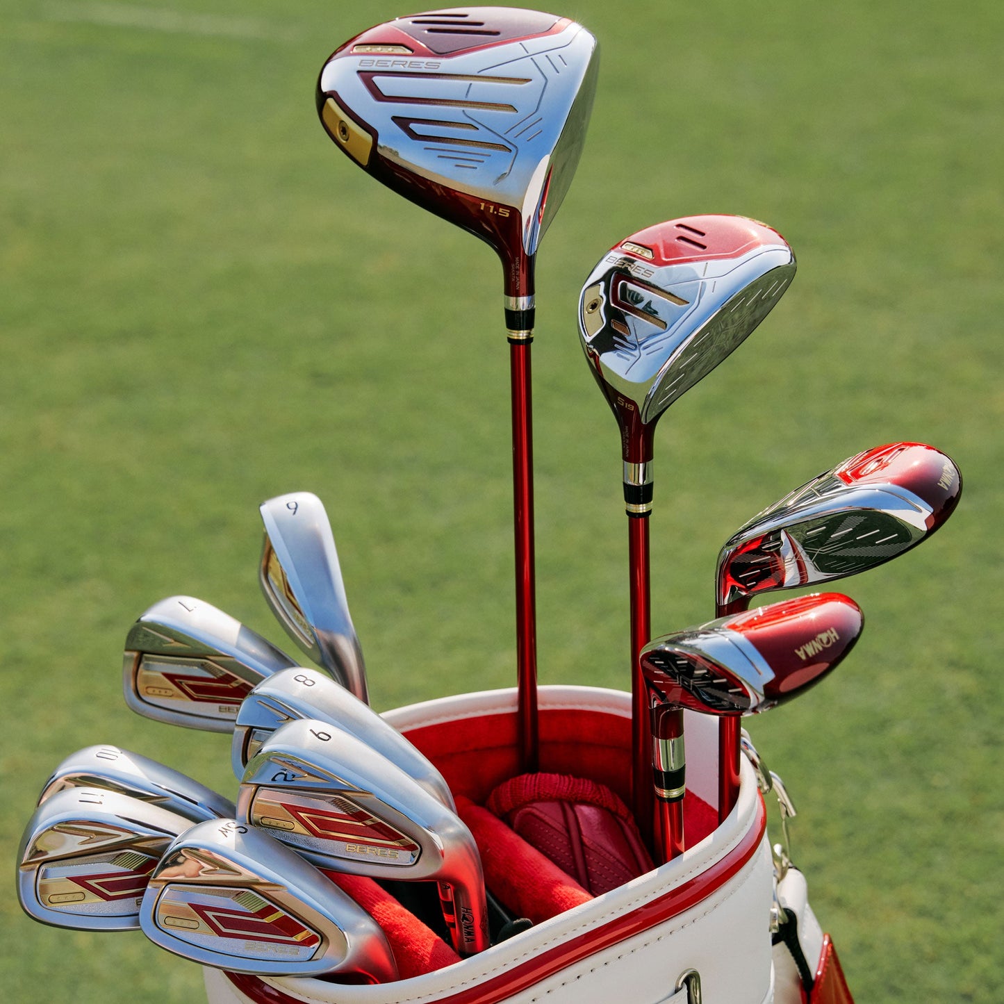 Golf clubs in a red and white bag on a grassy background