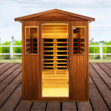 Wooden sauna with open door on a wooden deck, greenery in the background