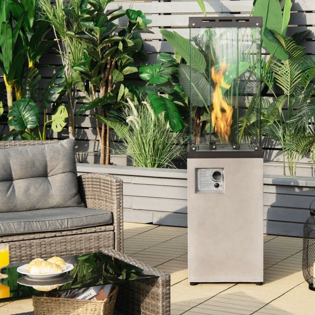 Outdoor patio scene with a fire pit, furniture, and plants.