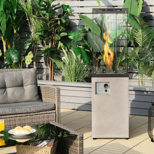 Outdoor patio scene with a fire pit, furniture, and plants.