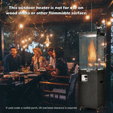 People enjoying a meal outdoors with an outdoor heater in the foreground.