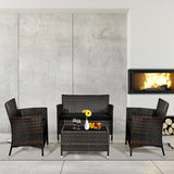 Outdoor furniture set with chairs and a table in front of a fireplace.
