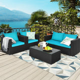 Outdoor patio set with blue cushions and a coffee table on a deck with scenic background.
