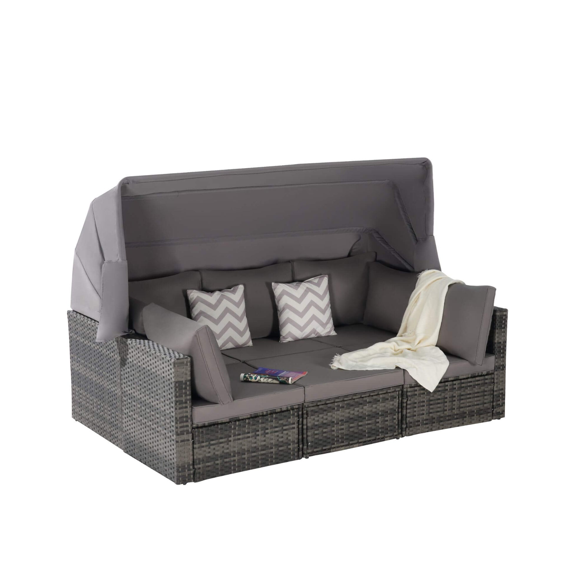 Outdoor sofa with cushions and a blanket on a white background
