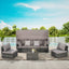 Outdoor patio furniture set with gray cushions on a patio with a pool and greenery in the background.