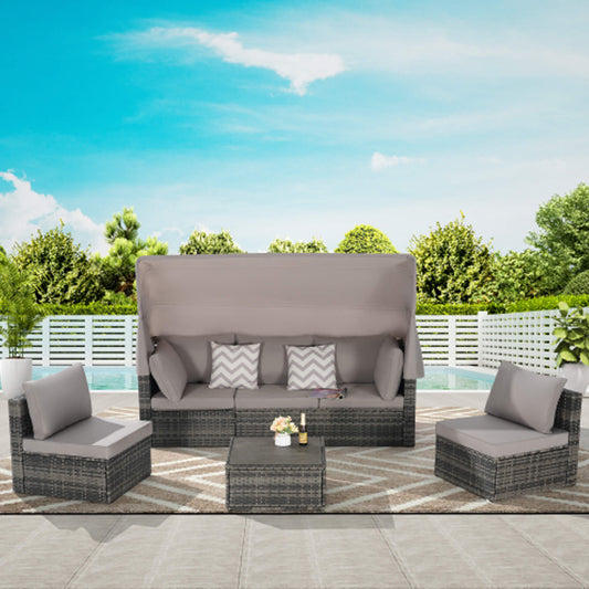 Outdoor patio furniture set with gray cushions on a patio with a pool and greenery in the background.