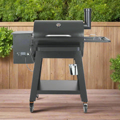 Black barbecue grill on a wooden deck with greenery in the background