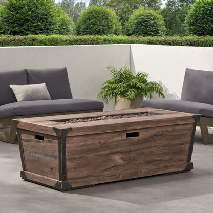 Wooden fire pit table on a patio with outdoor furniture and plants.