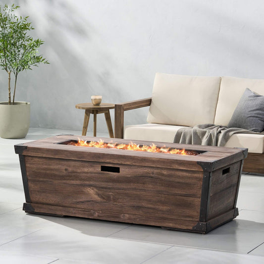 Wooden fire pit table with flames in a living room setting.