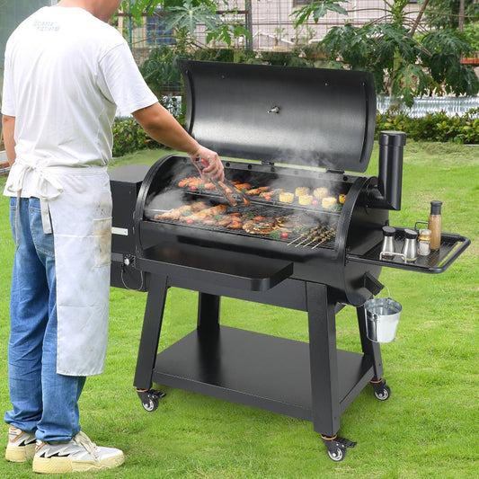 Person grilling outdoors using a large black barbecue grill on a grassy area.