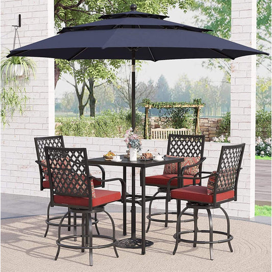 Outdoor patio set with table and chairs under a large umbrella on a patio.