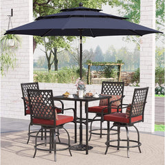 Outdoor patio set with table and chairs under a large umbrella on a patio.