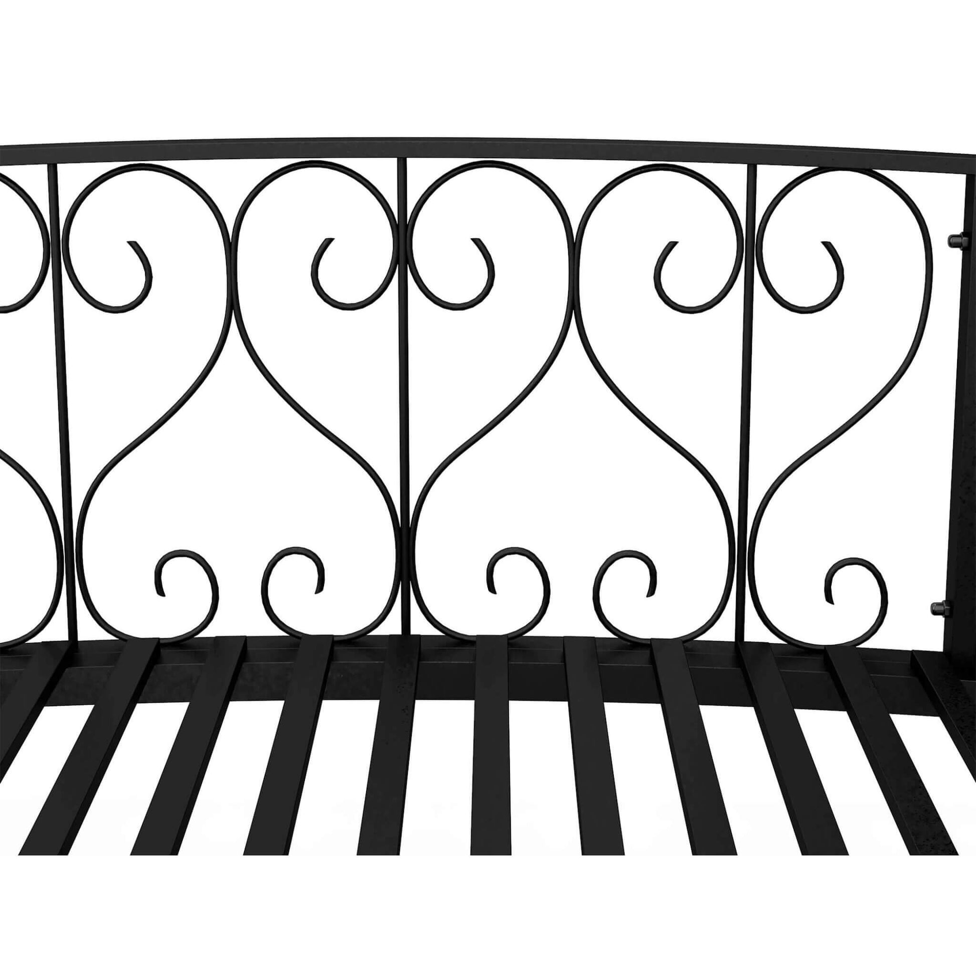 Decorative black metal railing with intricate designs on a white background