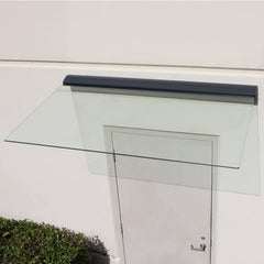 Glass door canopy with a white door and black trim on a light gray wall.