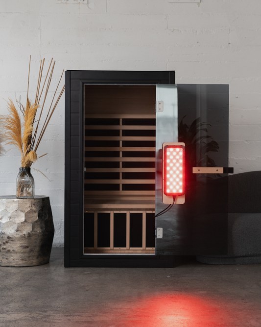 Infrared sauna with red light indicator on a gray wall background