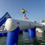 Rider balancing on Aquaglide Log Jam inflatable log obstacle – commercial aquapark balance and coordination challenge