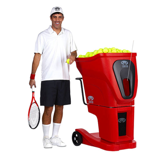 Man holding a tennis racket next to a red tennis ball machine filled with balls on a white background