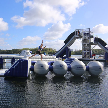 Aquaglide Helix inflatable aquapark obstacle full structure side view – 30 foot connected sphere balance course with jump station