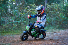 Child riding the MotoTec 24v 250w Electric Mini Bike Black safely outdoors