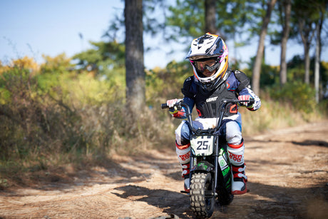 Black MotoTec 24v 250w Electric Mini Bike with steel frame and knobby tires on rough terrain
