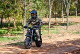 Black MotoTec 60v 1500w Electric Mini Bike with knobby tires on a dirt trail